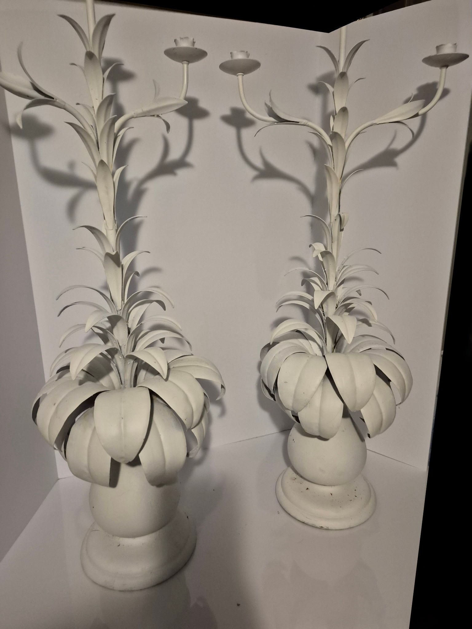 Mid Century Italian Wrought Iron Candleholders: A pair of painted white Italian wrought iron mid century large candleholders. Each is is 38"h x 28" in wide turns wood. These are very Palm Beach or Florida Regency .