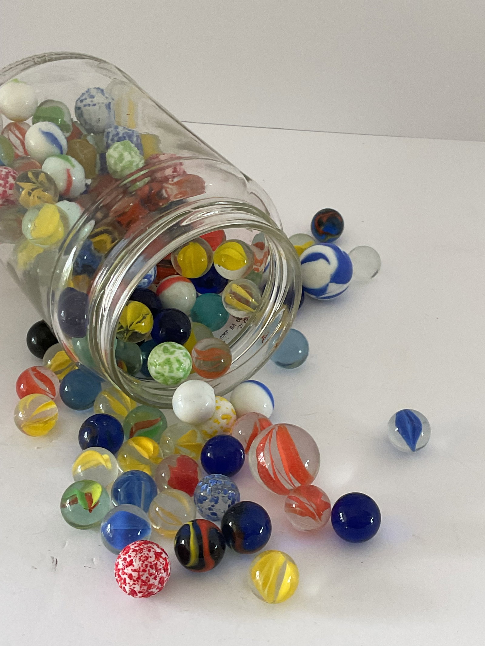Jar of Vintage Marbles: A jar of vintage marbles. The jar measures 6 x 4” and is full. None appear to react to black light. Some large 1”. Please see photos