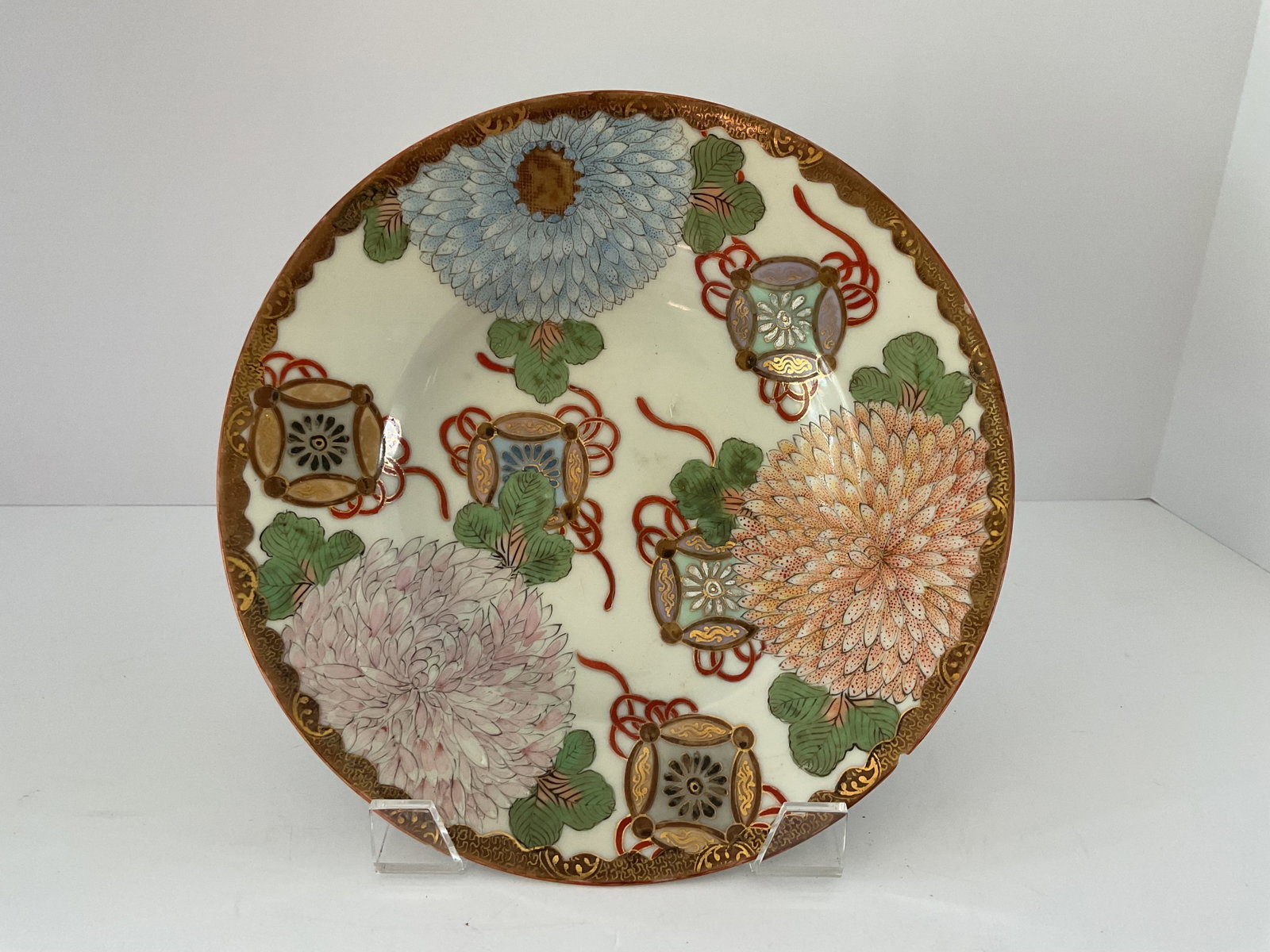 Japanese Kutani Porcelain Bowl Edo Period: An antique Kutani ware bowl featuring gilding and chrysanthemum flowers. Minor chip to edge, please see photos. It measures 10” in diameter and 2” in height, no markings.