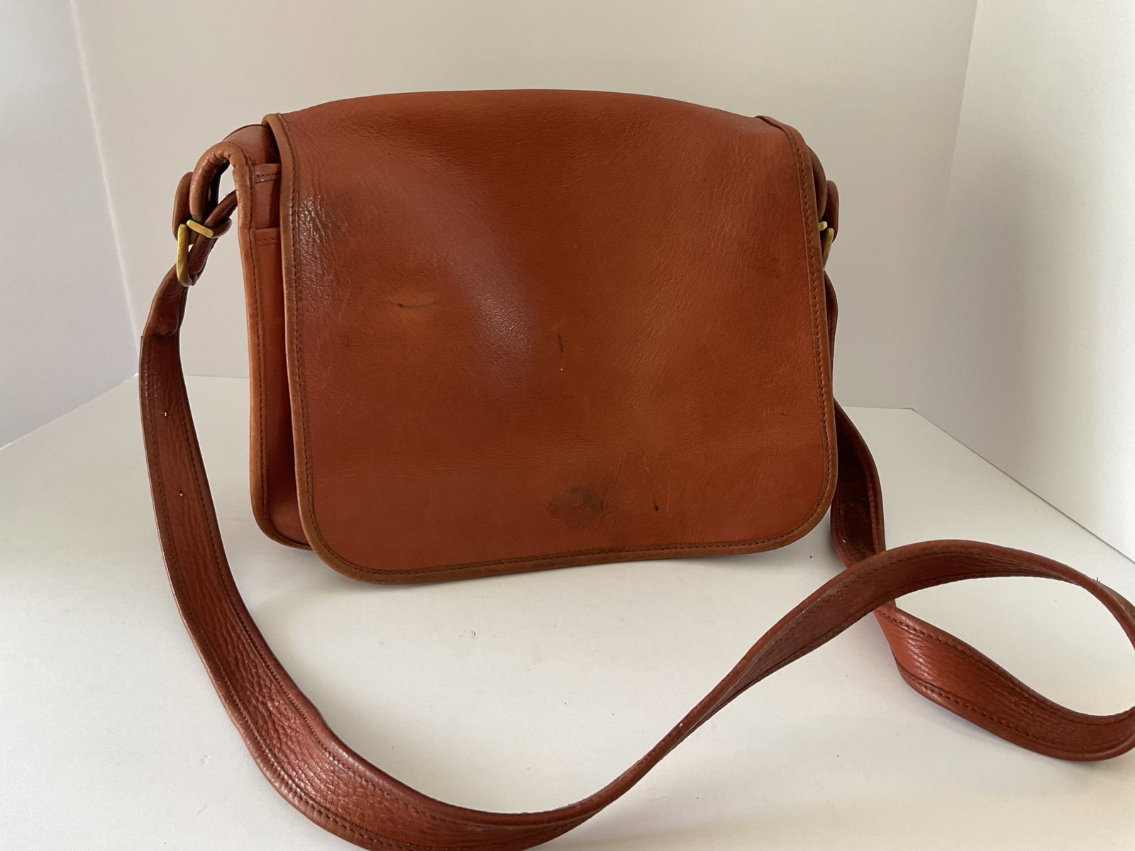 Vintage 80’s Coach Flap Bag: Vintage all leather Coach flap shoulder bag. This bag is classic unlined. Interior and exterior pockets. Minor marks to the exterior. Interior is very clean - please see photos. The bag measures 11 x 