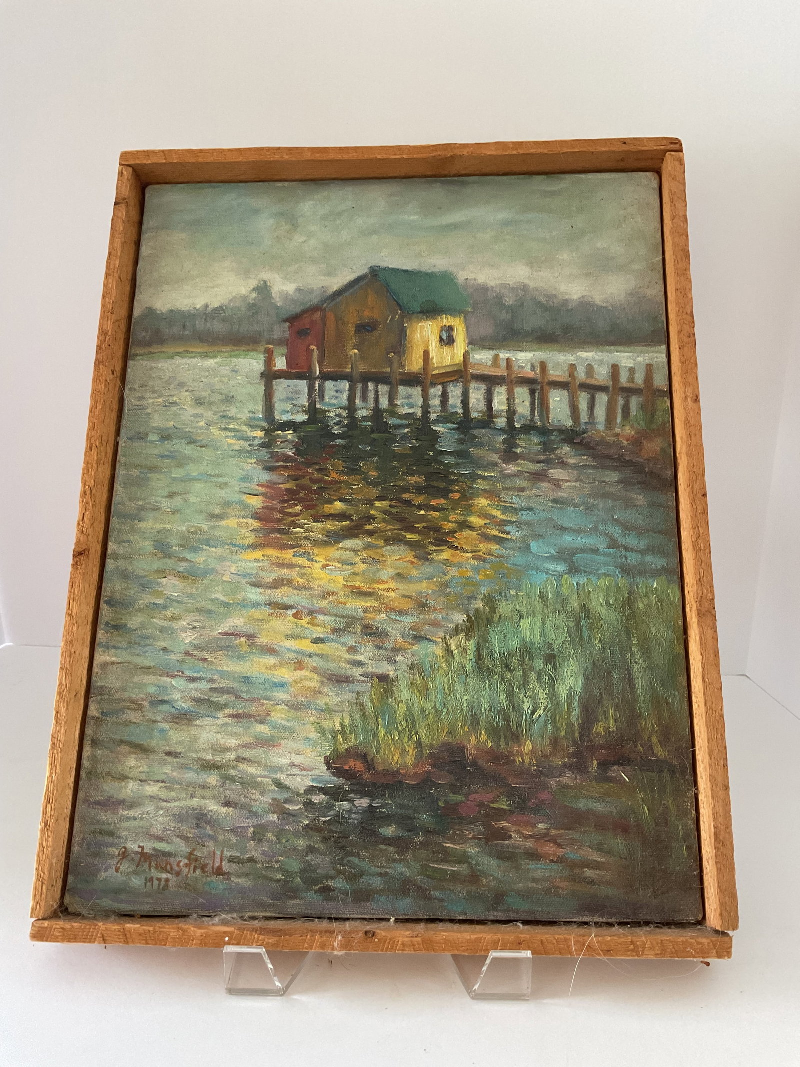 Impressionist 1978 G. Mansfield Oil on Canvas: This is an oil on canvas signed in paint to the lower left, G. Mansfield. It is dated 1978. Simple rustic wood frame. Features a boathouse river scene. 17 x 13”
