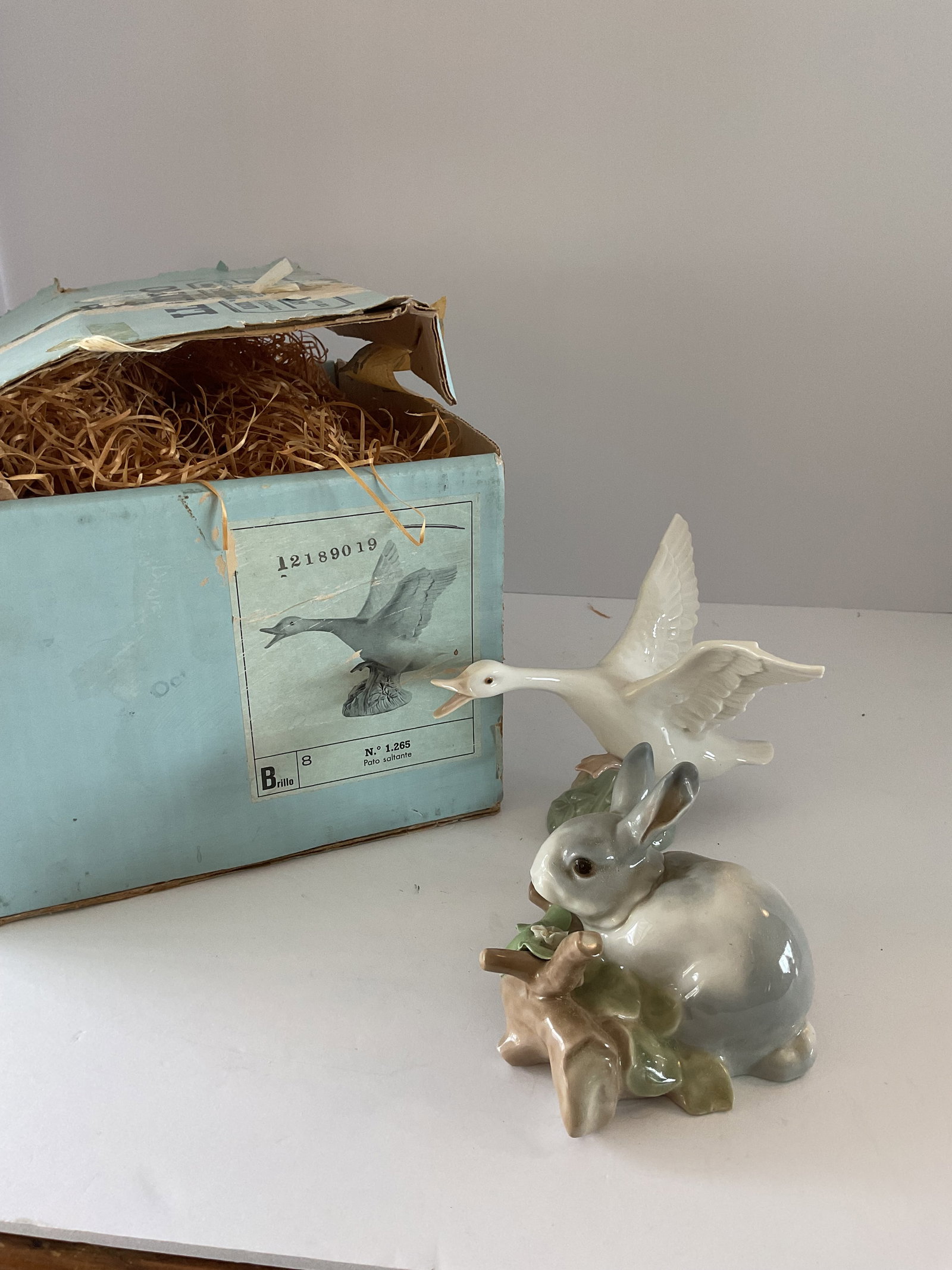 Two Lladro Animal Figurines with One Box: Included is a flying goose in the original box. Also included is a small bunny nestled in the woodland. The goose is number 61266. Each is approximately 6. 6”.