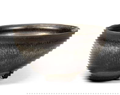 A Black Ceramic Bowl: D: 13cm H: 6.5cm