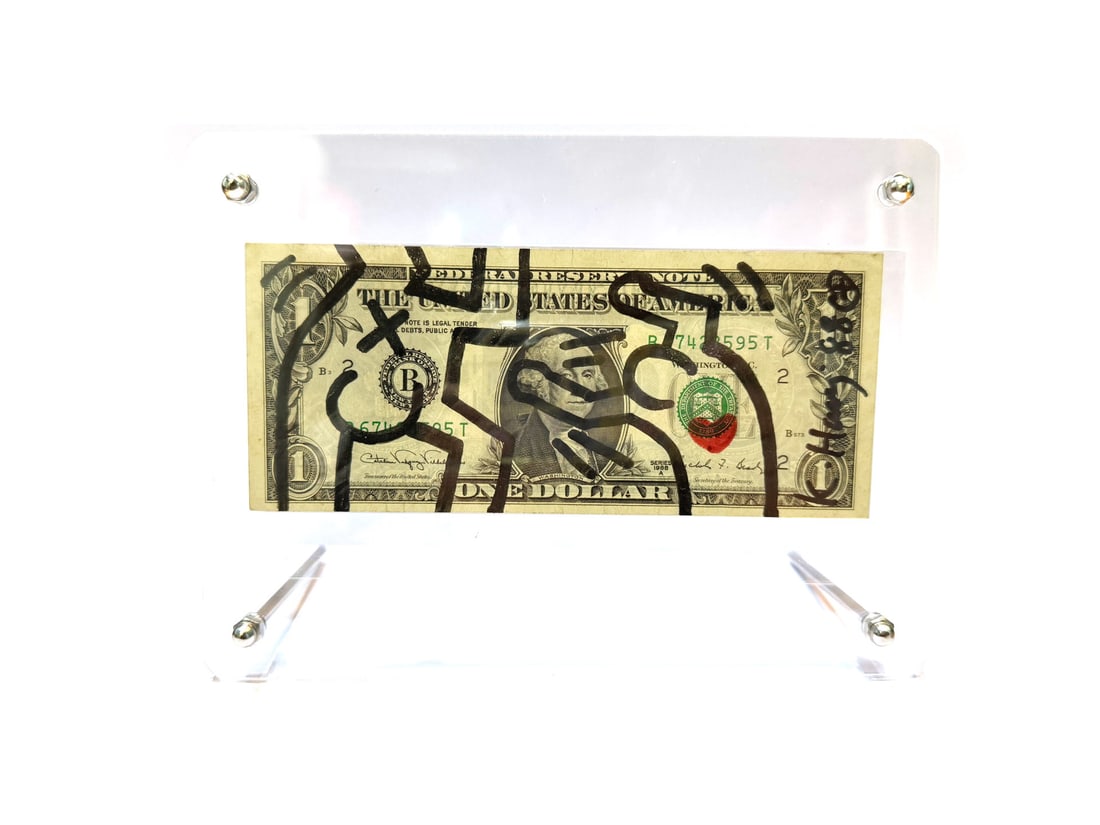 Keith Haring (1958-1990), Attributed To, One Dollar Bill Drawing: L: 15.6 W: 6.6cmKeith Haring (1958-1990) was a trailblazing American artist celebrated for his iconic and accessible visual language: His distinctive style, characterized by bold lines and vibrant col