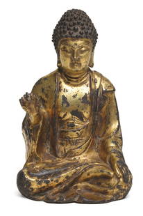 Gilt-Bronze Seated Buddha: H: 12.3 cmA gilt-bronze figure of Buddha seated in dhyanasana, the right hand raised in abhaya mudra, the left resting in dhyana mudra, the serene face framed by tightly curled hair, the surface with