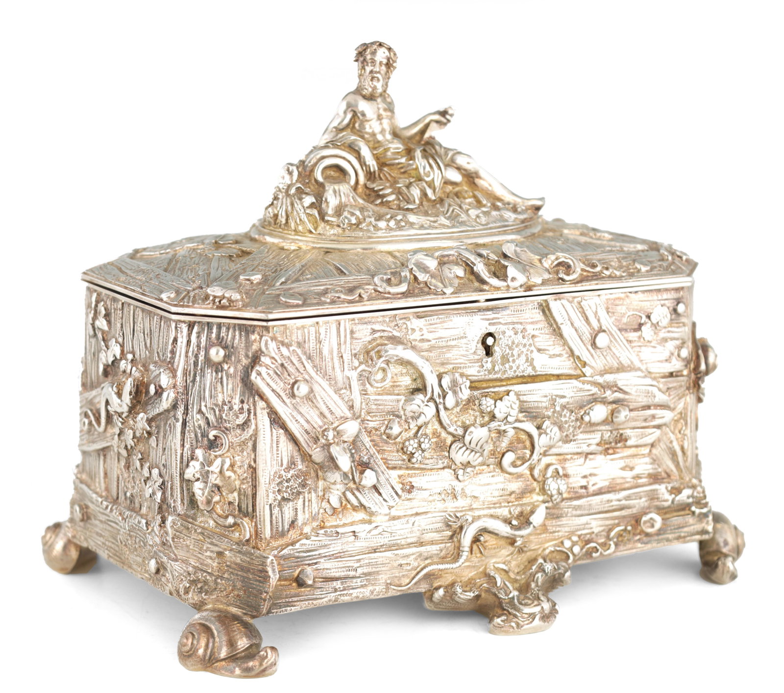 A Silver Jewelry Box: Dimensions: Height 18 cm; length 22 cm; width 15 cm. Description: A silver jewellery box of rectangular casket form, richly embossed with scrolling foliage, cartouches and figural ornament, raised on 