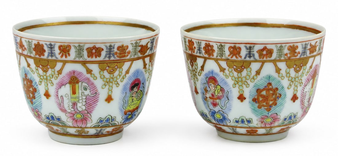 A pair of small Chinese famille rose porcelain cups: Dimensions: Diameter 8.8 cm; height 6.5 cm. Description: A pair of small Chinese famille rose porcelain cups or bowls, finely enamelled with reserves of flowers and ornamental devices. The compact rou