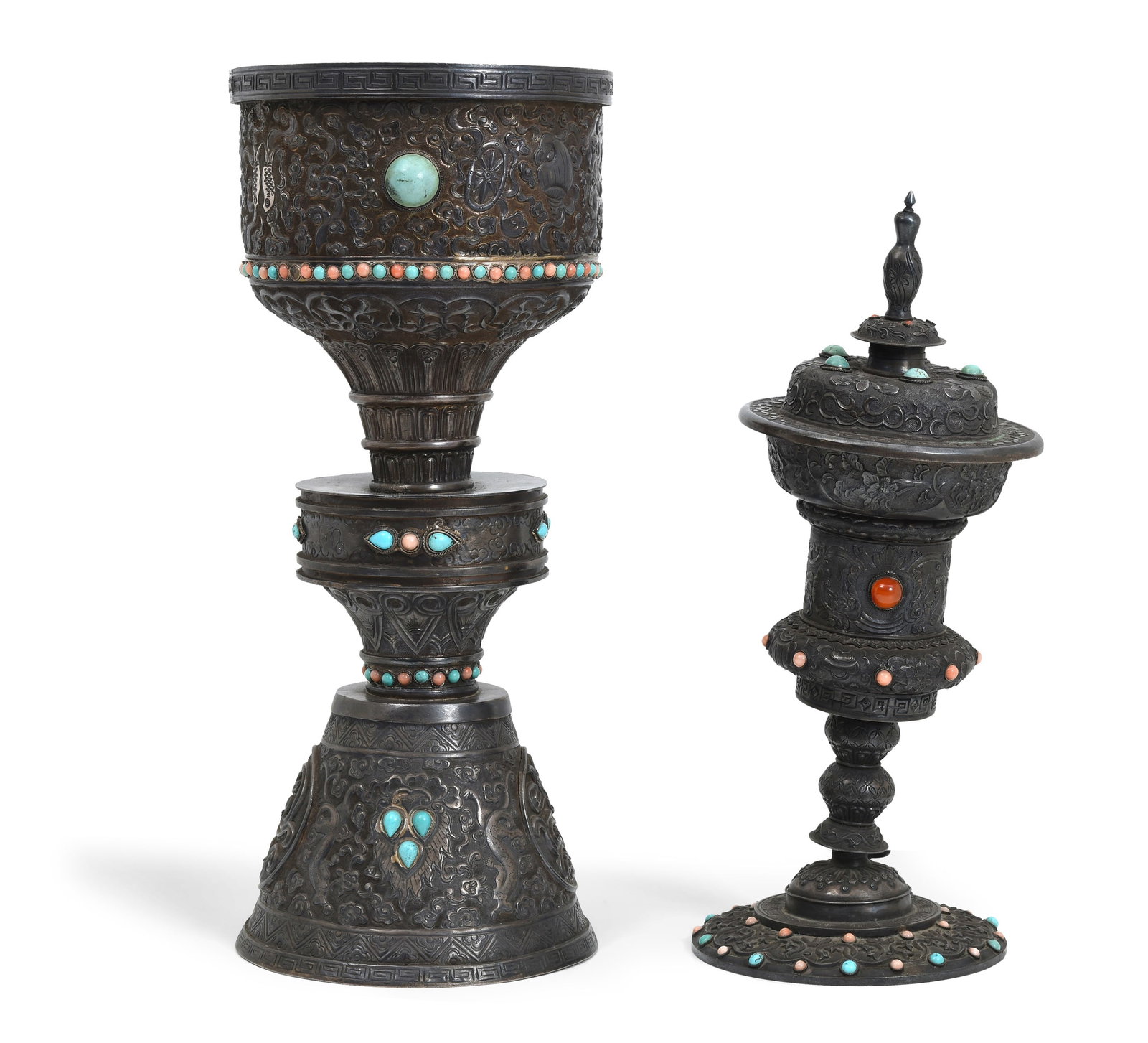 Two Tibetan ritual Buddhist silver lamps: Dimensions: Heights 28 cm and 25 cm. Description: Two Tibetan ritual Buddhist silver lamps, 19th/20th century, including a chalice-form butter lamp and a covered offering vessel. Each is enriched