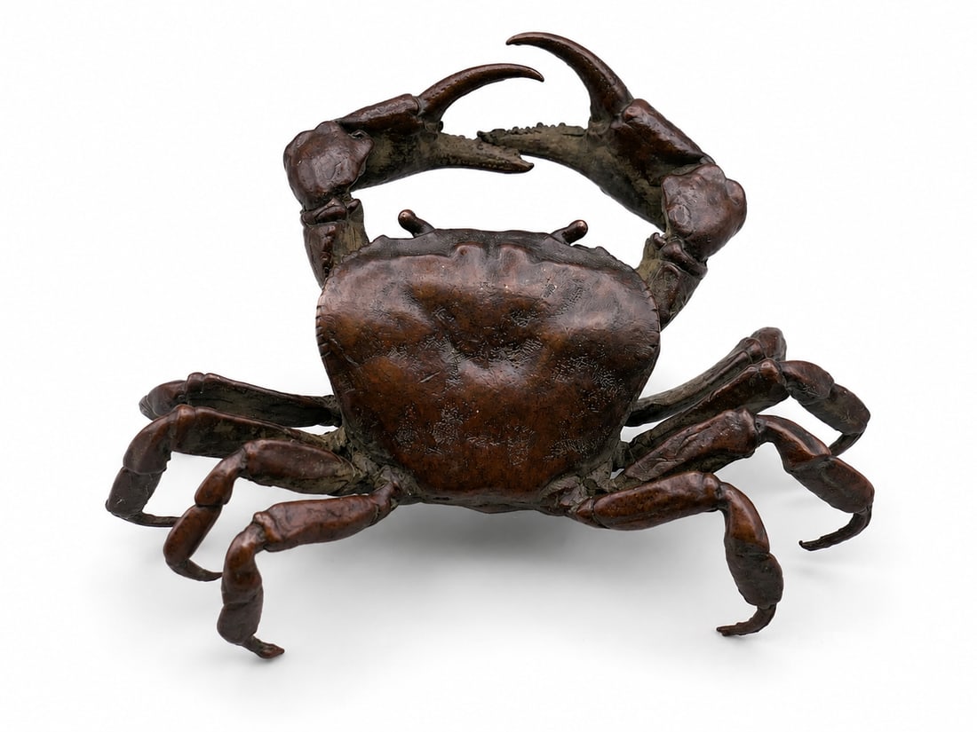 A bronze model of a crab: Dimensions: Width 11 cm. Description: A bronze model of a crab, naturalistically cast with articulated legs, raised claws and a textured shell. The warm brown patination accentuates the modelling and 