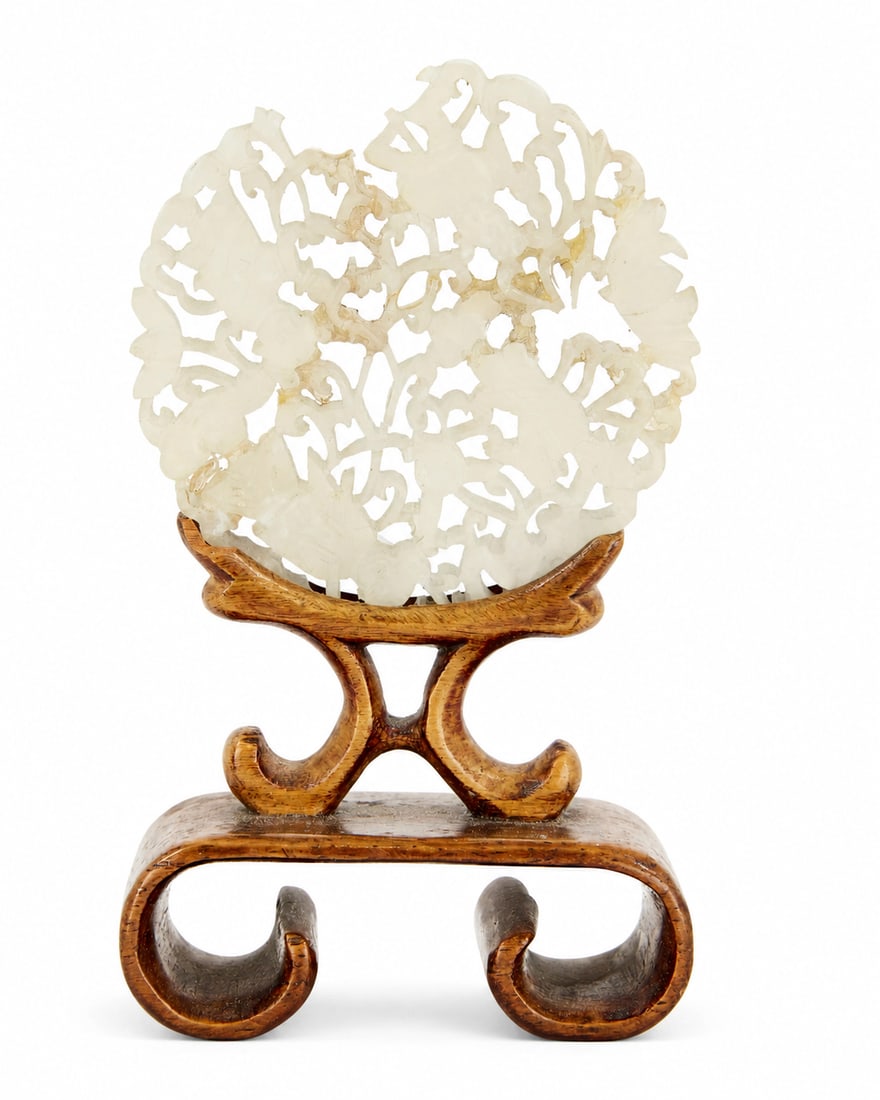 A Chinese pale-green jade circular 'boys' plaque (1 of 1)