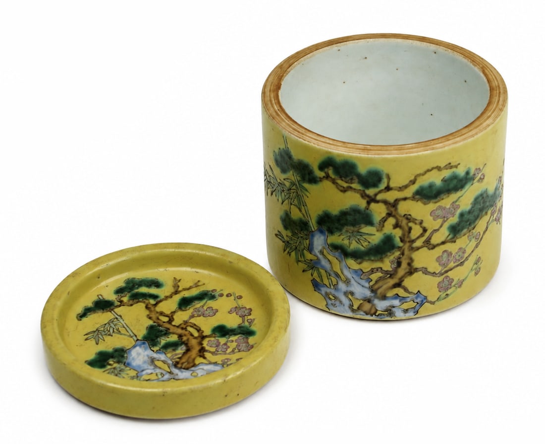 A small Chinese enamelled covered jar: Dimensions: Height 9.8 cm; diameter 10.2 cm. Description: A small Chinese enamelled covered bowl or jar, yellow-ground 'pine tree and rock' vessel, the base decorated with a taiji (yin-yang) motif.