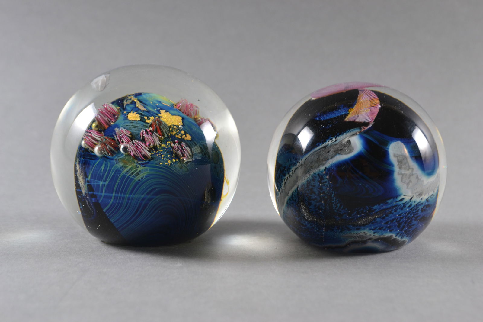 Josh Simpson (American), Two Planets Series Paperweights, 1985, 1990, 1992: Oceanic and earth-like forms and colors, both signed Simpson, dated and numbered at base, H: 2 1/2"