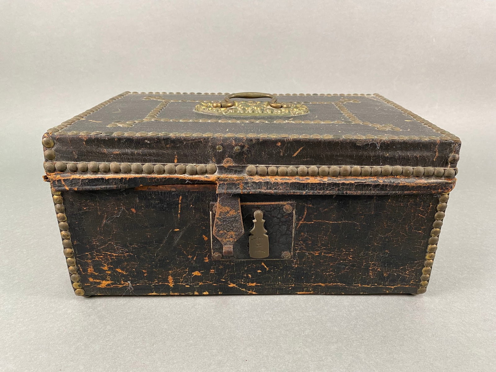 19th Century Leather And Nail Head Decorated Document Box Labeled John B. Baker Manufacturing,: Retains original Label: John B. Baker Manufacturer of Saddles, Traveling Trunks, Valises, Military Caps & Equipment, original lock, H: 6, w: 12, d: 8 inches