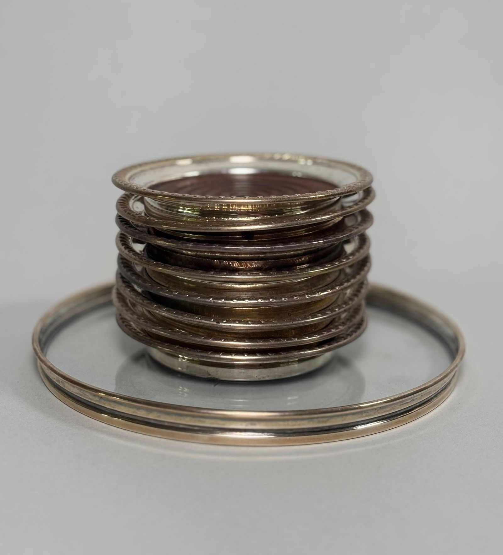 Group Of Eight Matched Sterling Silver Coasters Together With Gorham Sterling And Cut Glass Wine: coasters have wood base mounted with sterling repoussée rims marked “sterling”; Dia: 4 incheswine coaster is hallmarked and numbered dia: 6 inches