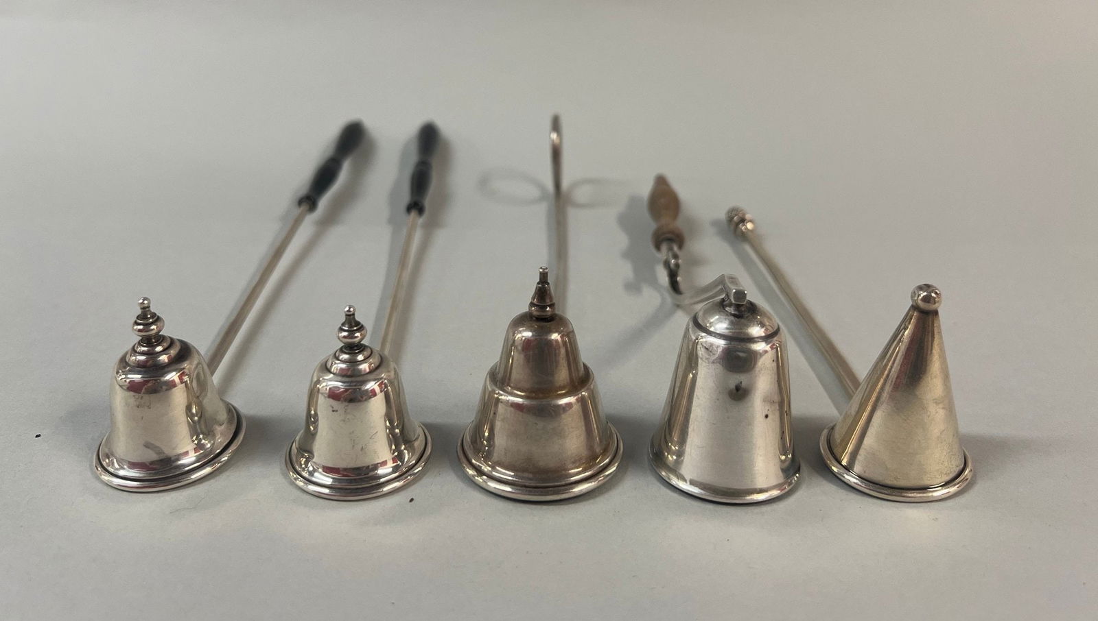 Collection Of Sterling Silver Candle Snuffs Including Tiffany & Co And Gorham (5): Gorham Snuffs - L: 9 3/4 inches. total weight 3.72949 OztCONDITION: wood handle on one of the Tiffany snuffs is broken off as photographed all snuffs are in used condition
