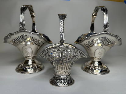 Shreve And Co. Pierced Silver Basket And A Pair Of Plated Baskets: A monogrammed pair stamped Shreve &amp; Co./Sterling with reticulated body and foot and stationary handle: H: 9 x w: 6 1/2 x d: 4 3/4 inches together with a monogrammed German basket hallmarked above
