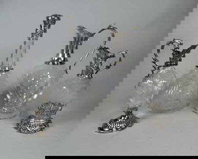 Silver Mounted Ewers And A Decanter (4): Large ewer hallmarked at shoulder: H: 11 dia: 5 inches; small ewer with etched glass body stamped at neck and foot: H: 8 1/2 x d: 3 inches; small ewer with turned glass body - stamped under foot: H: 9