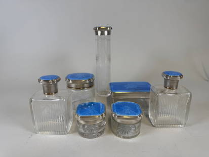 Blue Guilloche Enamel And Sterling Silver Eight-Piece Vanity Set, London, 1928: consisting of 2 small round covered boxes one larger round covered box a rectangular box two perfume bottle shoehorn an oblong jar each piece hallmarked along rim of lid together with a silver backscr
