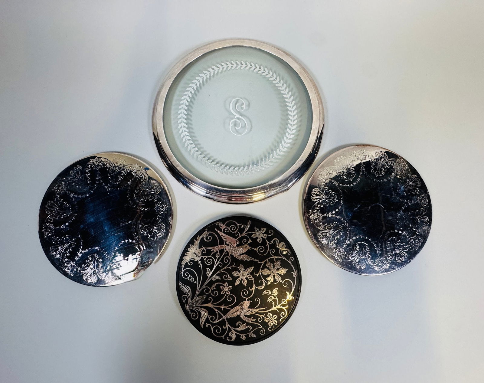 Collection Of Silverplate Trivets (4): various sizes and styles smallest dia: 6 inches; largest dia: 9 inches