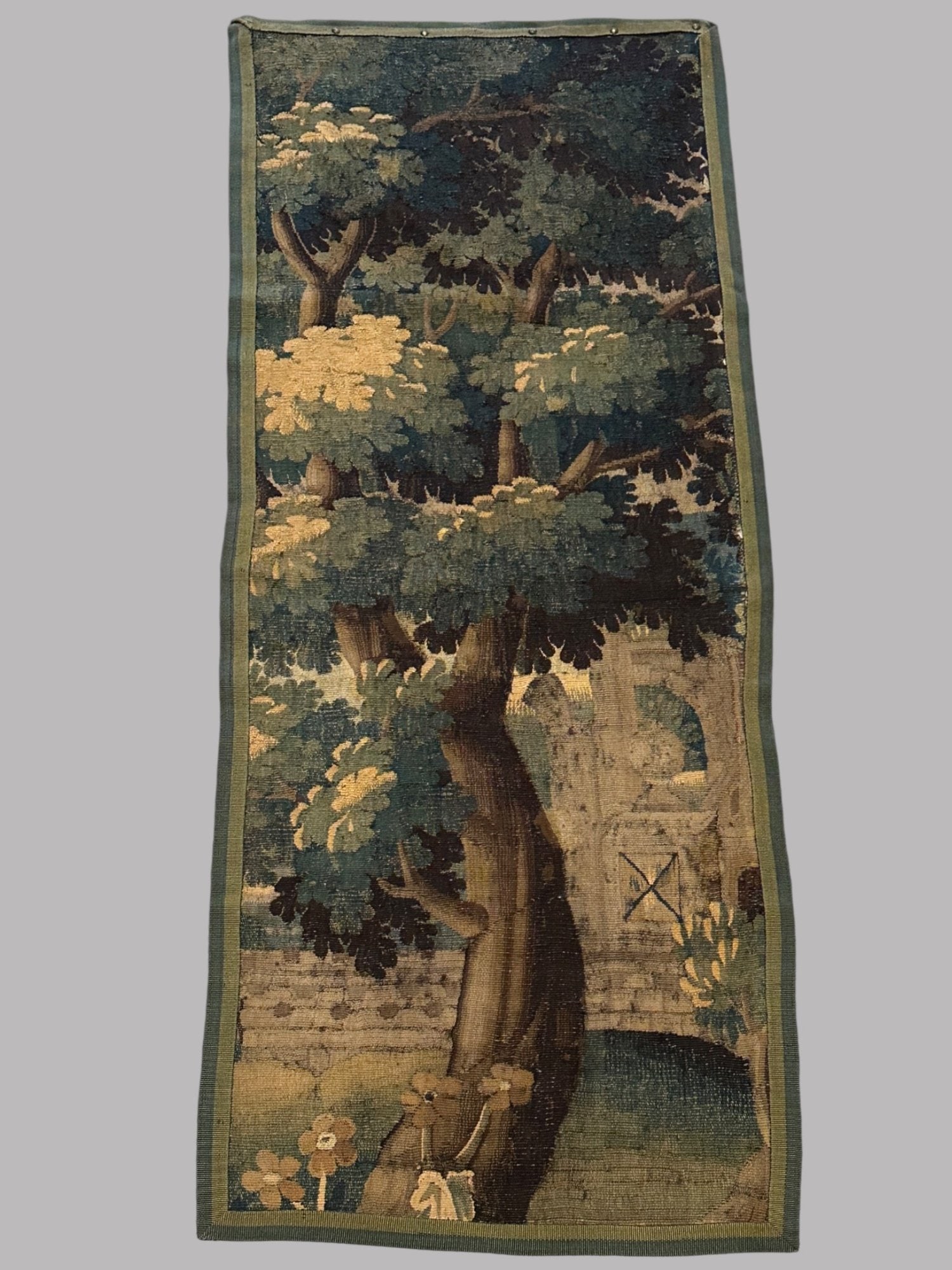 Flemish/Belgian Tapestry Panel, 16-17th Century: 20x70 inchesCONDITION: Border added later; evidence it has been cut down from larger tapestry; center section of linen fabric added to back to reinforce; wooden board attached to border at top edge wi