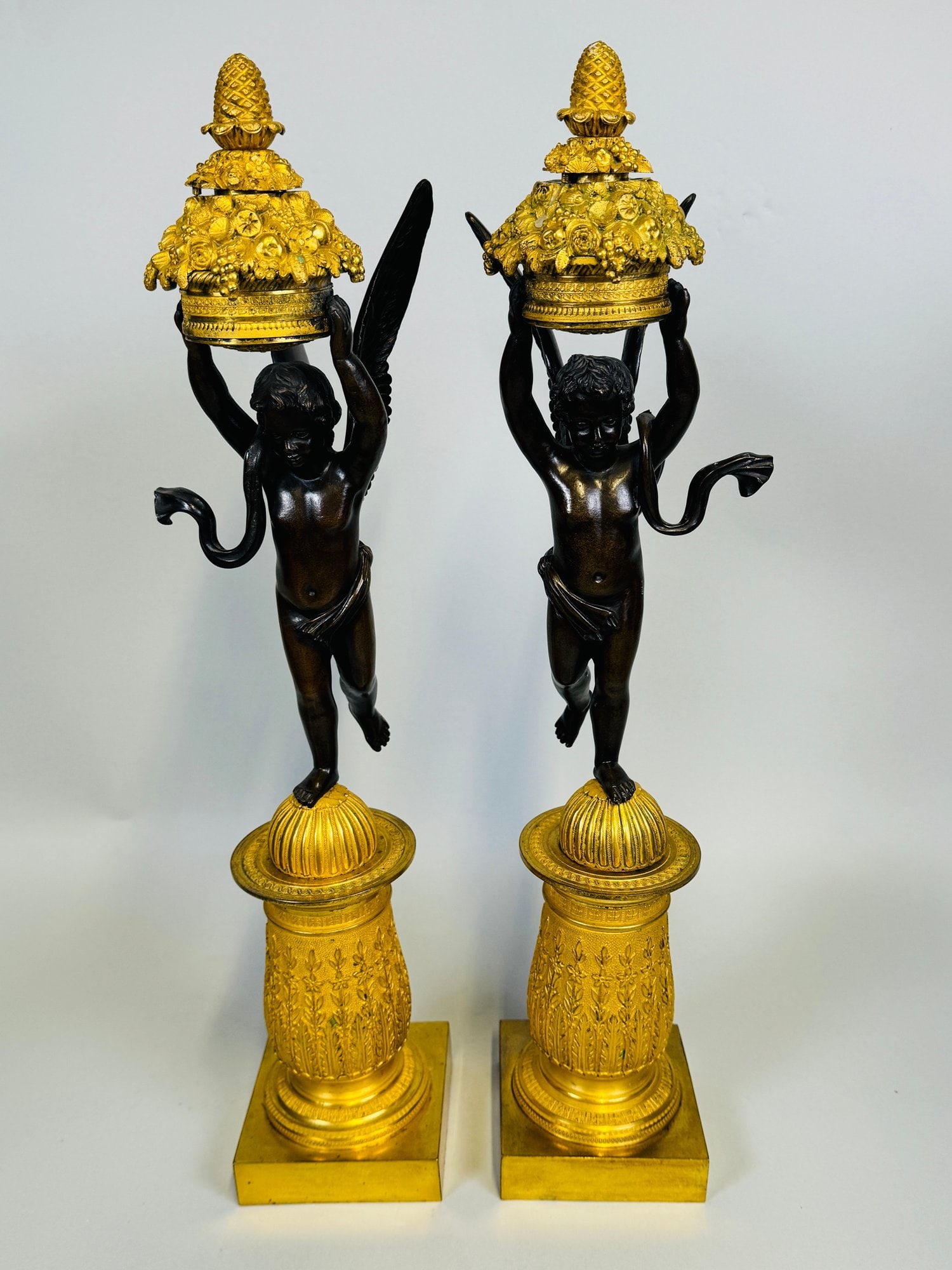 Pair Of Fine French Empire Parcel-Gilt Bronze Cassoulets, 19th Century: H: 19 3/4 x w: 4 x d: 5 inches CONDITION: wings loose on one figure areas of oxidation to gilding