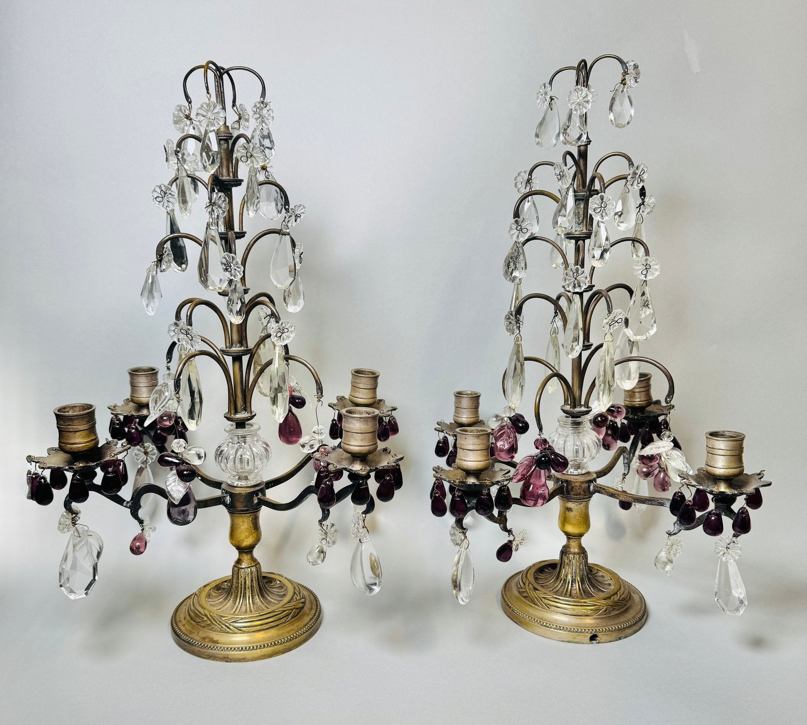 Pair Of French Clear And Amethyst Glass Girandoles: atop brass bases previously wired for electricity Height: 17 1/2 inches
