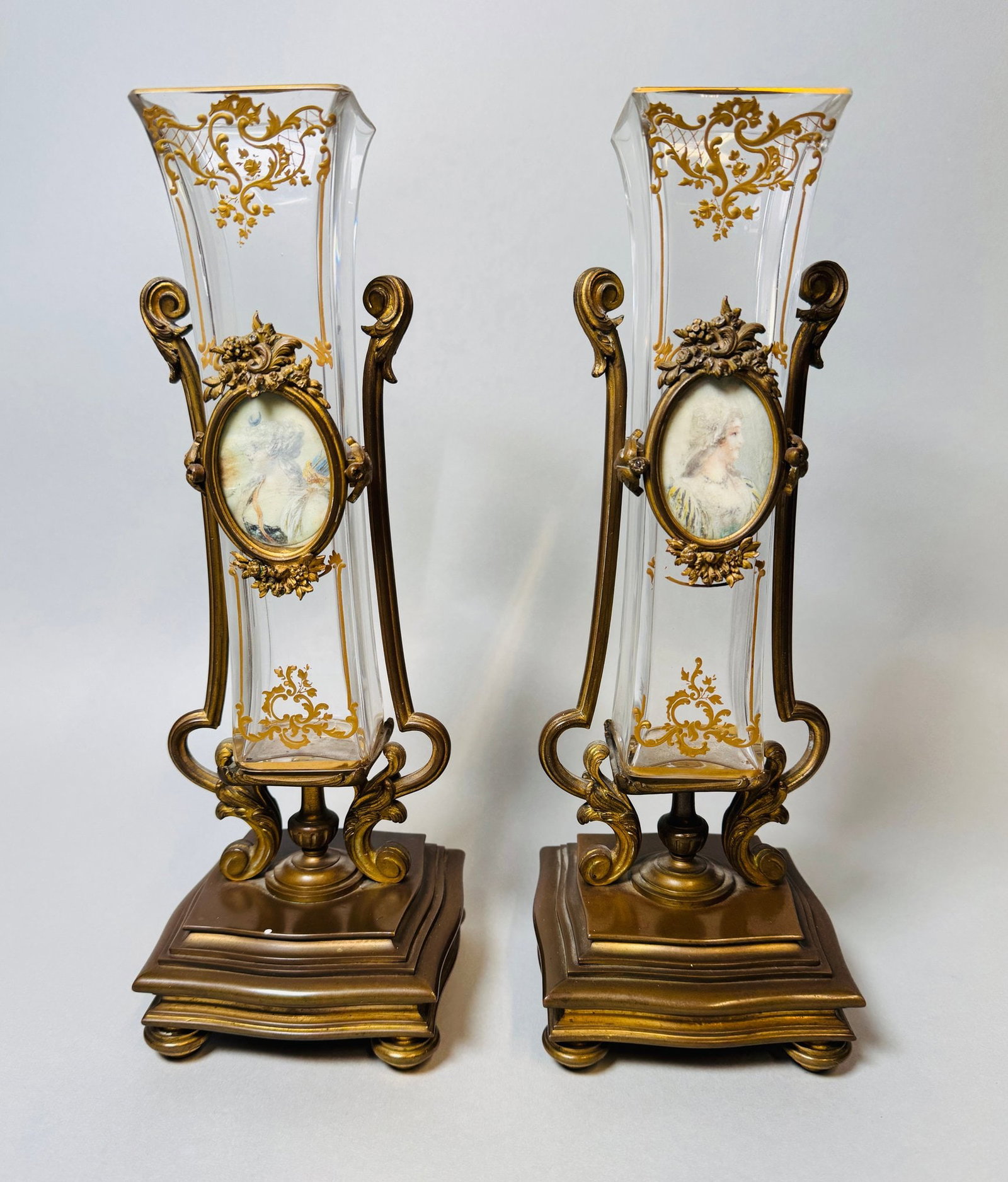 Pair Of French Gilt Glass And Bronze Mounted Vases, Late 19th Century: each with a hand painted plaque of a lady in period dress impressed numerals to underside Height overall: 11 3/8 inches