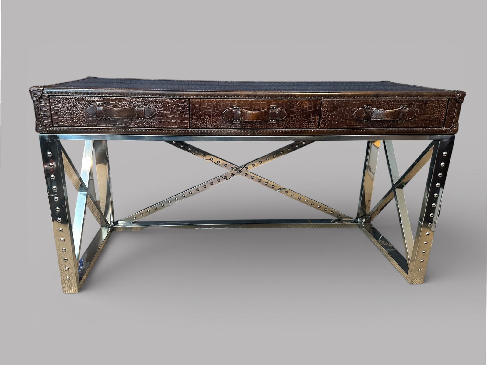 Steamer Style Leather And Chrome Writing Desk: having a faux crocodile embossed leather on top and x-form chrome legs H: 31 1/2 x w: 59 1/8 x d: 23 3/4 inchesCONDITION: some scratching/rubbing on surface stain to the top of the desk