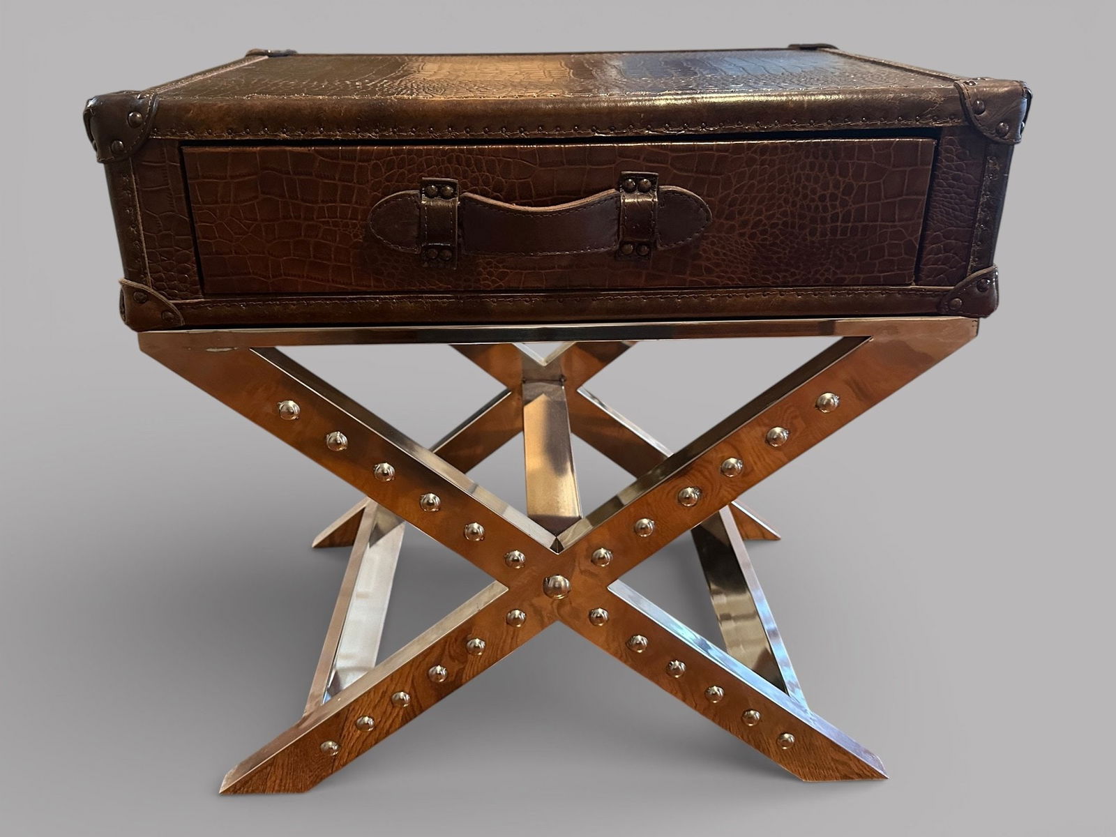 Steamer Style Leather And Chrome Side Table: having a faux crocodile embossed leather on top and x-form chrome legs H: 24 x w: 24 x d: 16 inchesCONDITION: minor scratches on leather