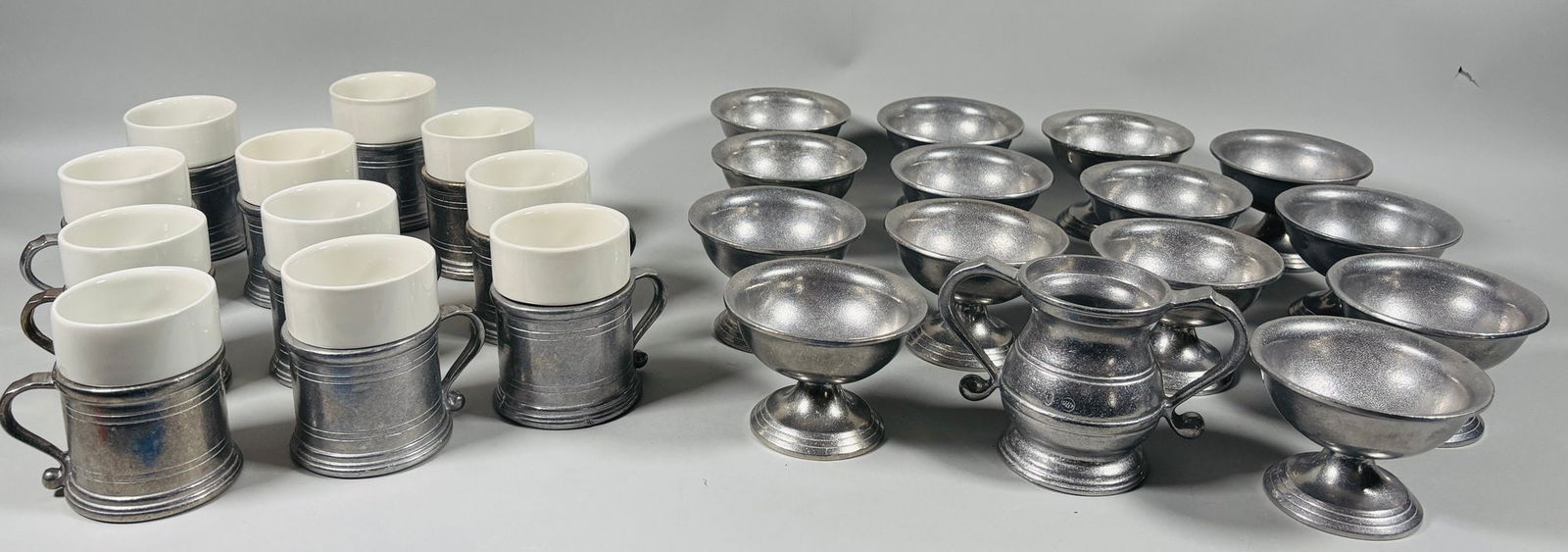 Wilton Armetale Plough Tavern Low Sherbet Bowls And Coffee Mugs (23 Pieces): Together with an open sugar bowl (1) h: 4 inchesSherbet bowls (12) h: 3 inches Mugs with ceramic insert (10) h: 4 inches