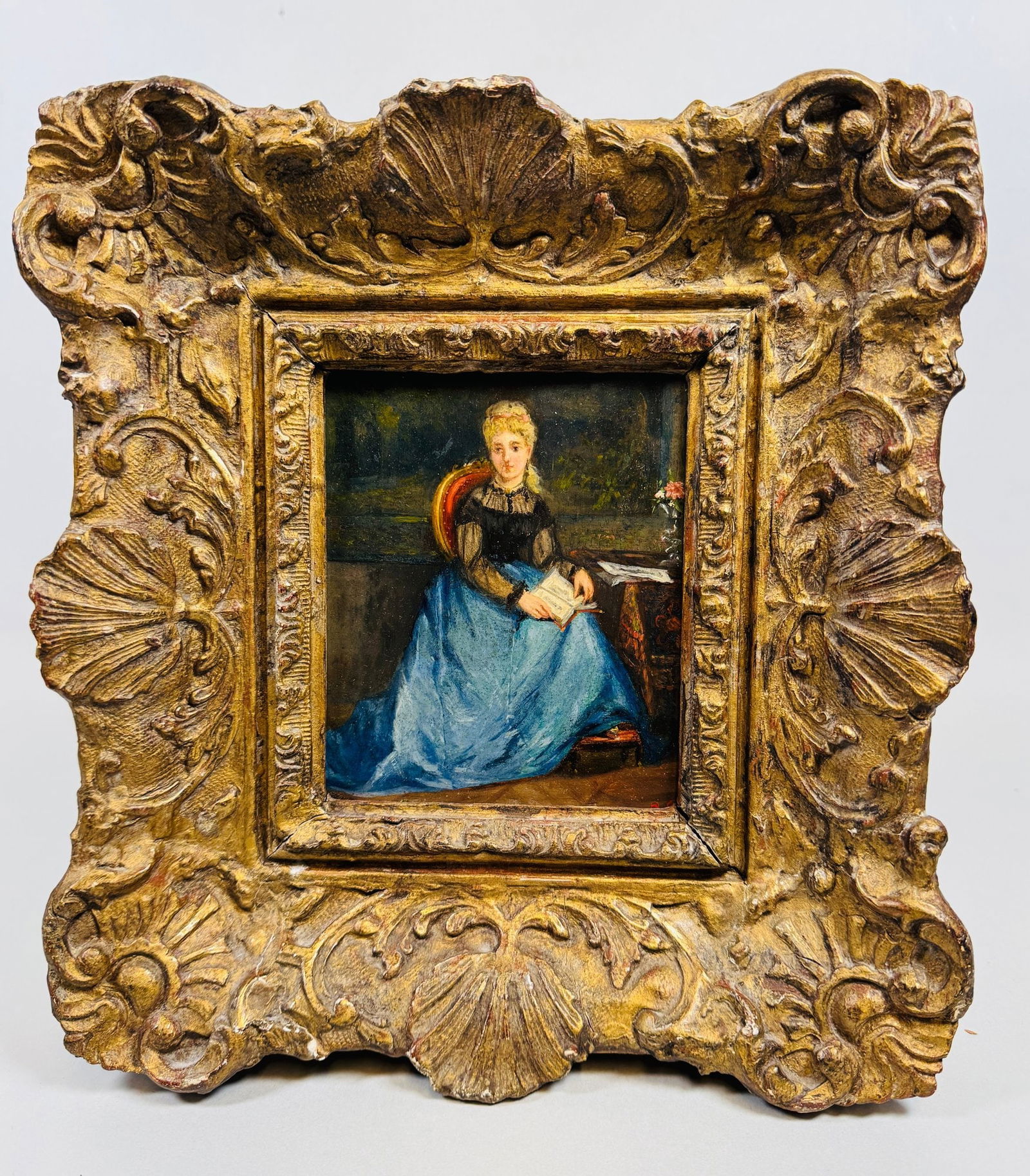 Unknown Artist, Portrait Of A Lady Reading, Oil On Panel, C. 19th Century,: Signed at lower right signature is obscured; set in antique carved giltwood frame h: 11 1/4 x w: 10 3/4 inches (framed) h: 5 1/2 x w: 4 1/2 inches (sight)CONDITION: frame has a few minor chips scuffs
