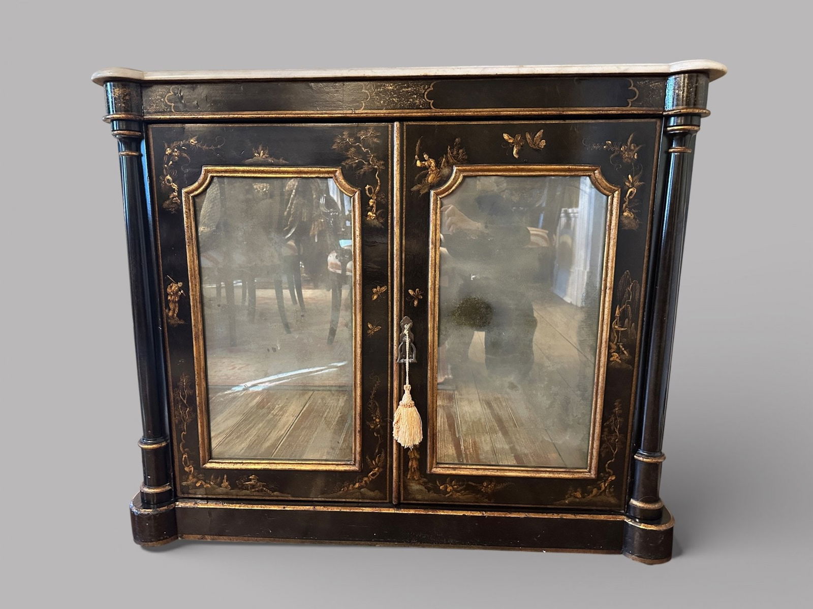 Ebonized And Parcel Gilt Chinoiserie Style Marble Top Two-door Cabinet, 20th Century: Two mirrored doors open to two shelves h: 35 1/4 x w: 42 1/4 x d: 13 3/4 inchesCONDITION: some wear to gilt elements