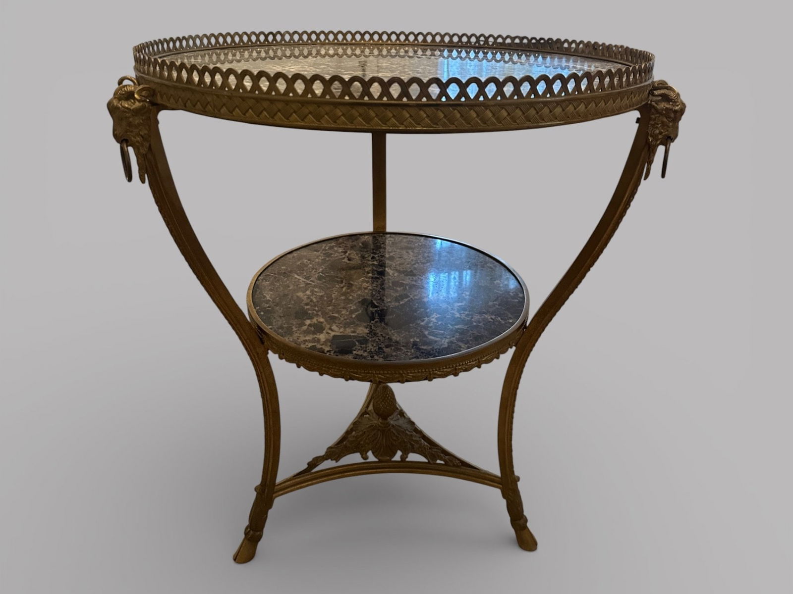 Louis XVI Style Gilt Metal Gueridon: marble top with gallery rams head and ring legs and hoof feet H: 30 x dia.: 36 inches