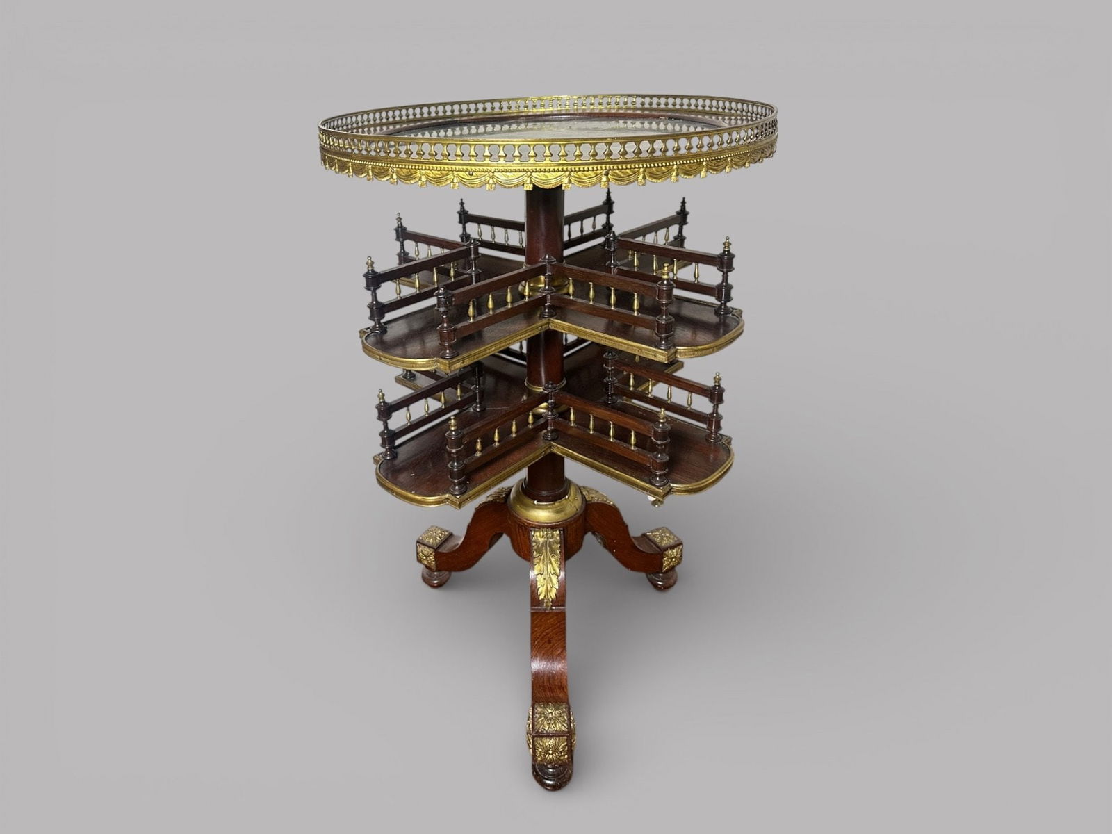 Victorian Revolving Book Stand: Marble top and gilt metal mounted with two revolving circular shelves over tripod feet h: 31 1/2 x dia: 21 inches CONDITION: