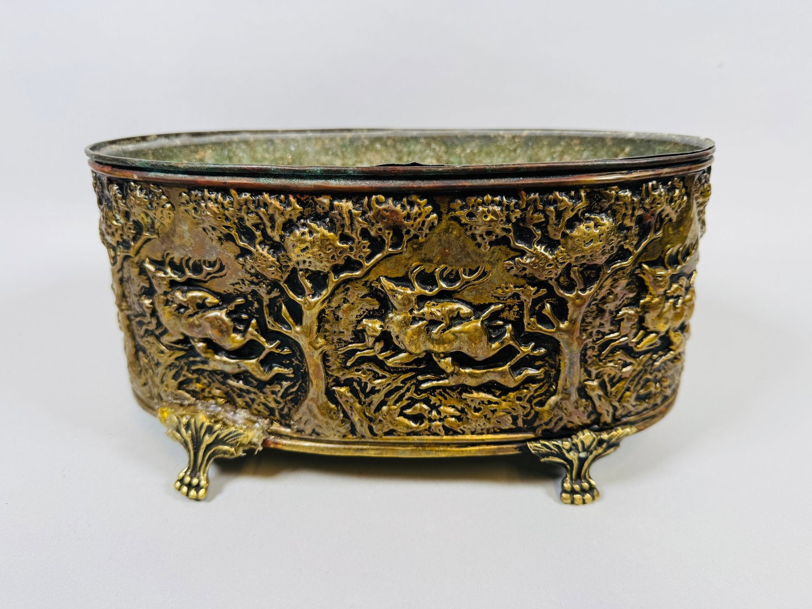 Antique Pierced Gilt Metal Jardiniere: Woodland scenes all round h: 6 x w: 11 x d: 6 1/2 inchesCONDITION: two feet have been repaired with glue that is visible; this damage can probably be fixed by a qualified restorer