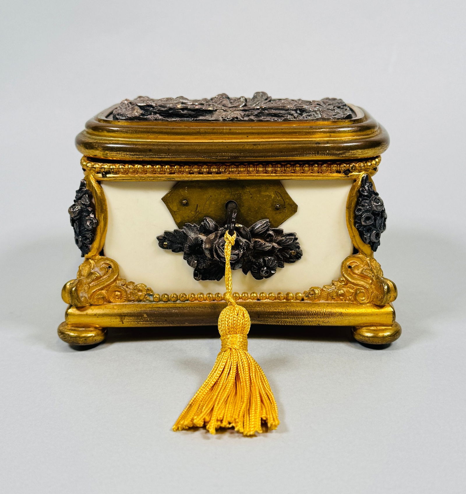 Gilt Brass Mounted Jewelry Casket With Silvered High Relief Panel On Lid, C. Late 19th Century: retains original key h: 3 1/4 x w: 5 x d: 3 inches CONDITION: lock does not work some minor discoloration to metal areas silk lining dry and loose