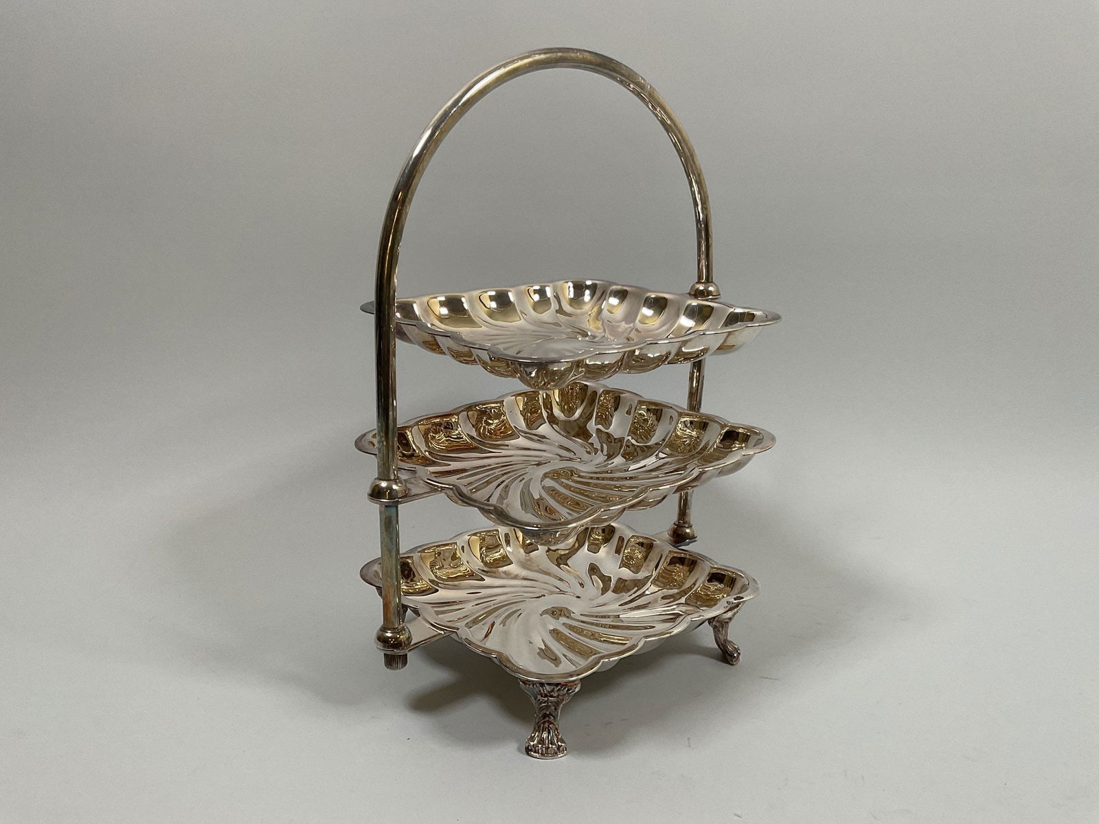 Silver Plated Three Tier Cake Stand: marked 957 underneath the upper two tiers rotate and are removable h: 11 x w: 8 x d: 6 inches (overall)
