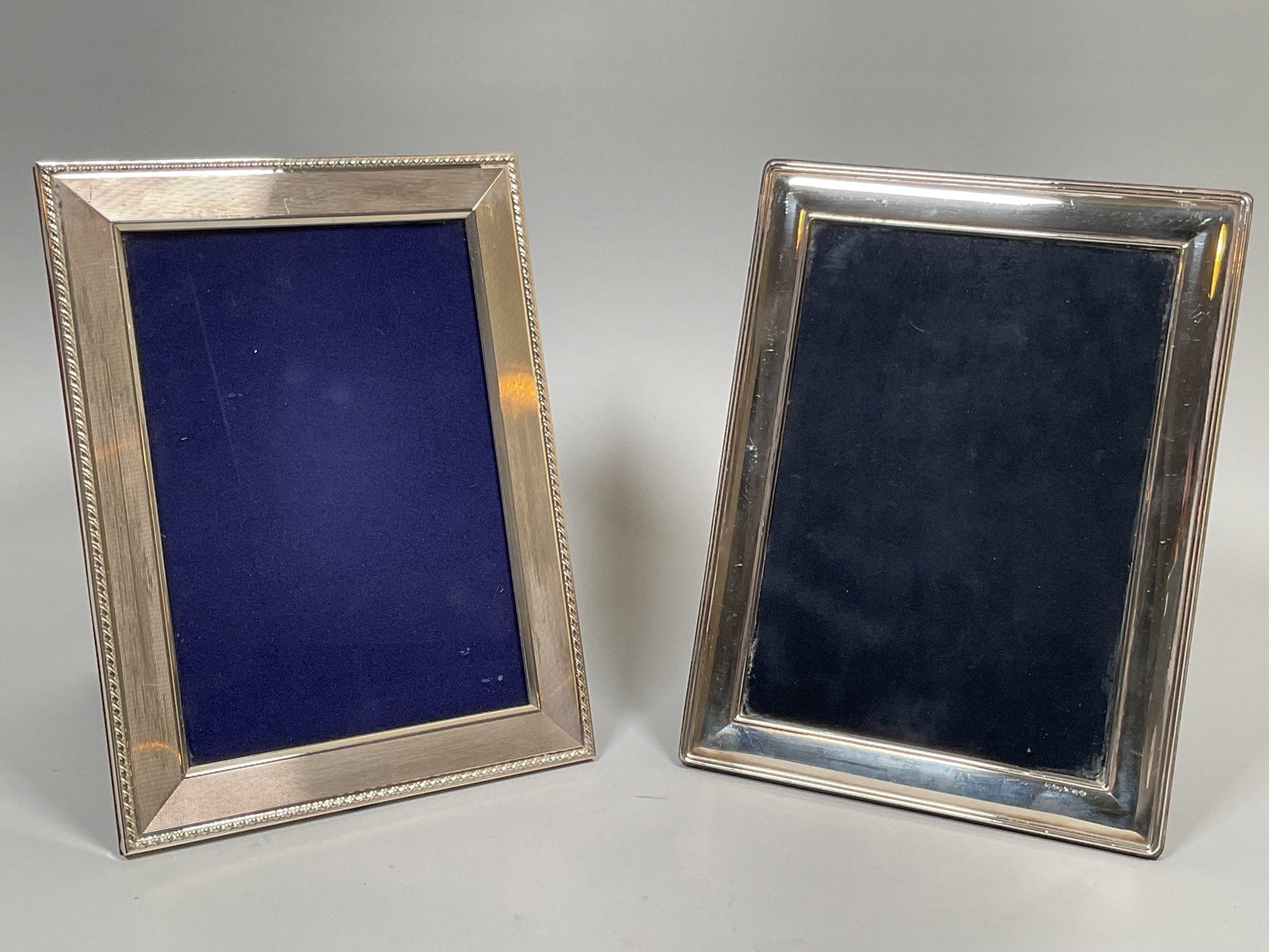 English Silver Picture Frames (2), Modern, 2000: Both marked 925 one with twisted rope border and makers mark GF h: 8 3/8 x w: 6 3/8 inches (overall); h: 7 1/2 x w: 5 inches (opening); the other h: 8 1/4 x w: 6 1/4 inches CONDITION: light minor scra