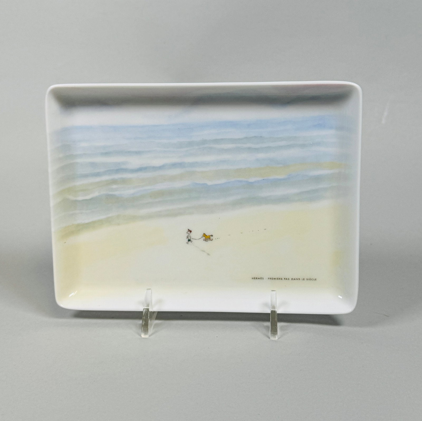 Hermes 'Premiers Pas Dans Le Siecle' Porcelain Trinket Tray: w: 6 1/4 x d: 4 3/4 inches CONDITION: excellent