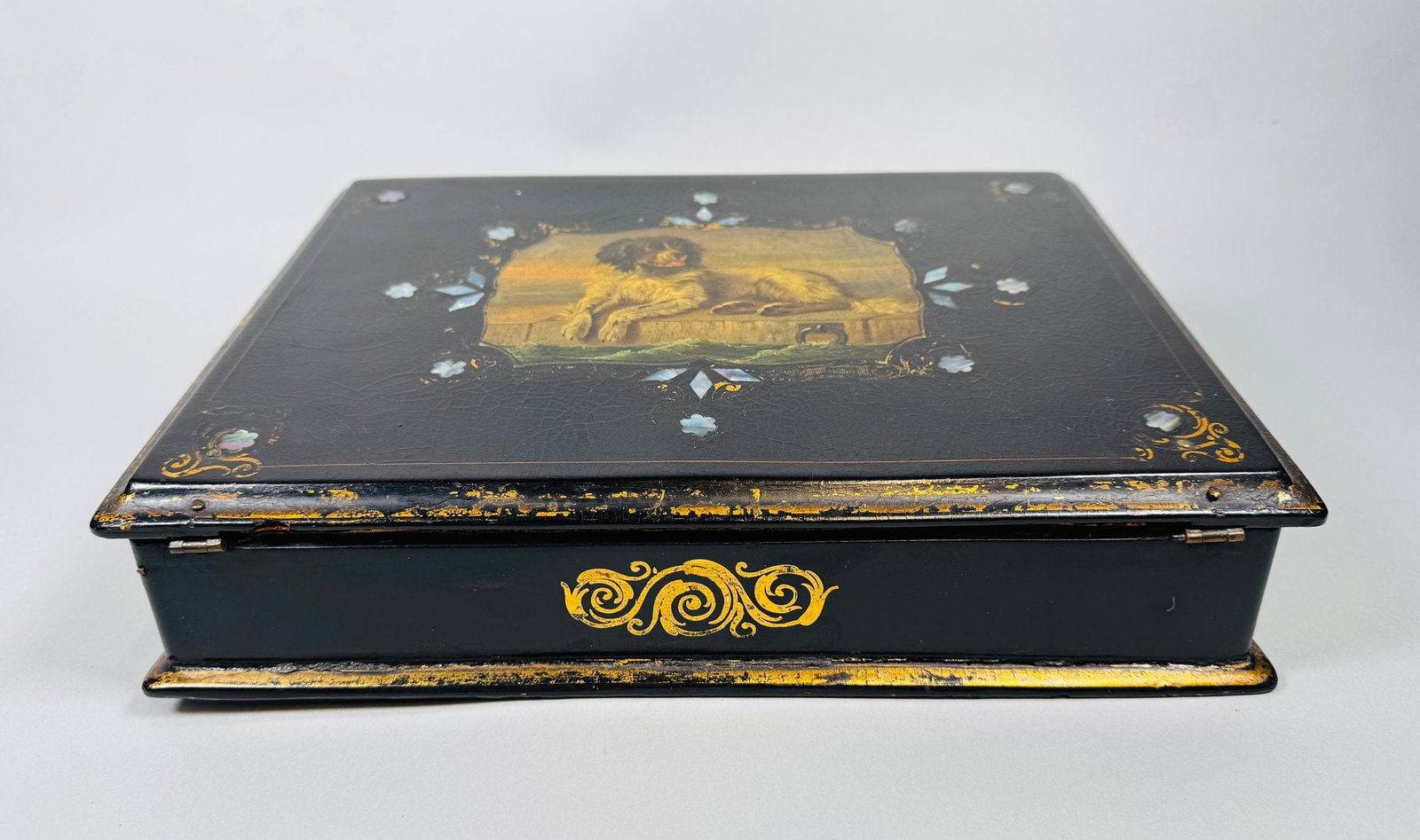 Victorian Papier Mache Writing Slope: Japanned and painted with central medallion of a retriever dog with mother-of-pearl inlay and painted gold details opening to a velvet writing surface and interior fitted for writing implements h: 4 x