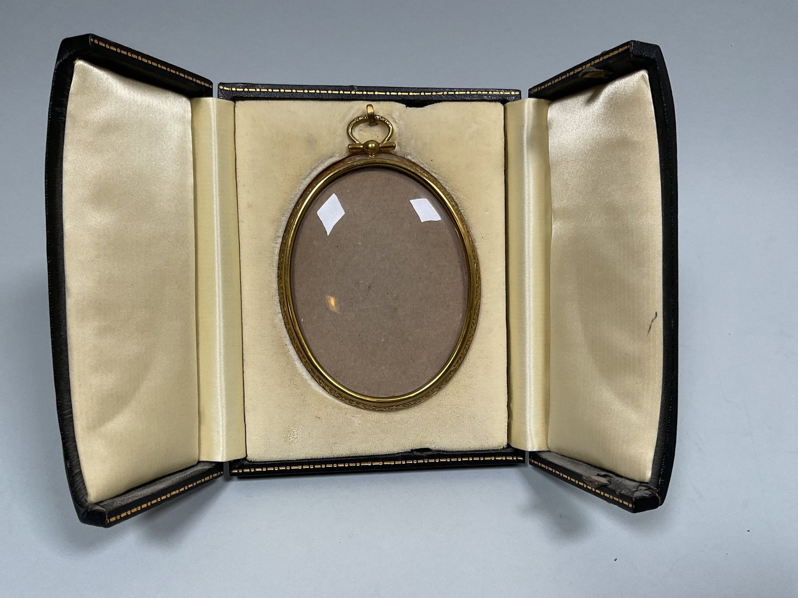 Antique Gold Tone Miniature Photo Pendant Frame In Stand Up Tooled Leather Case: Case h: 5 1/2 x w: 4 3/8 inches; frame h: 4 1/4 x w: 3 3/4 inches (overall) h: 3 1/4 x w: 2 3/8 (interior)