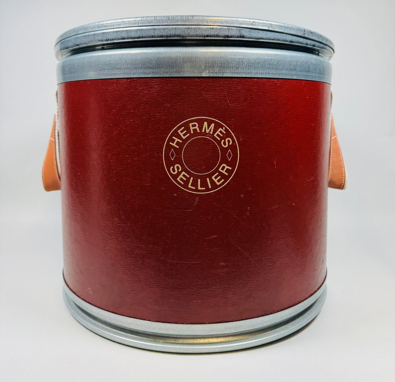 Hermes Sellier Small Saddle Box: Rust red H: 12 x dia.: 14 1/2 inchesCONDITION: lid is badly dented