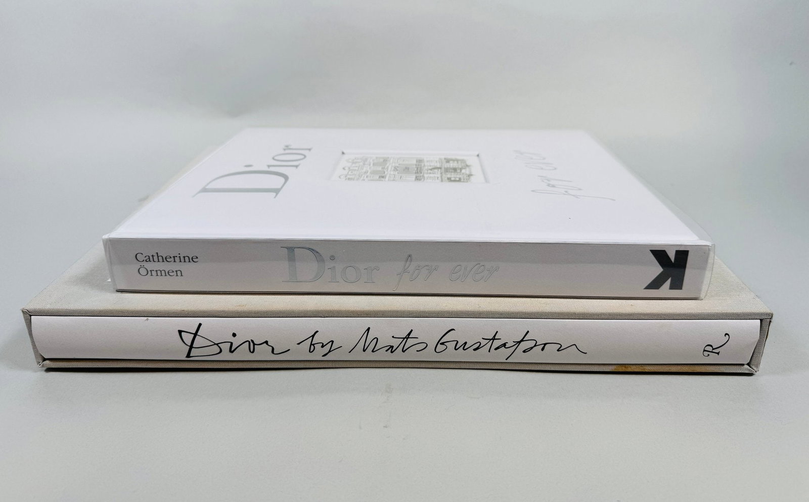 Two Dior Coffee Table Books: Includes Dior by Mats Gustafson Rizzoli New York and Dior Forever by Catherine OrmenCONDITION: excellent other than one minor stain on exterior case of Rizzoli book