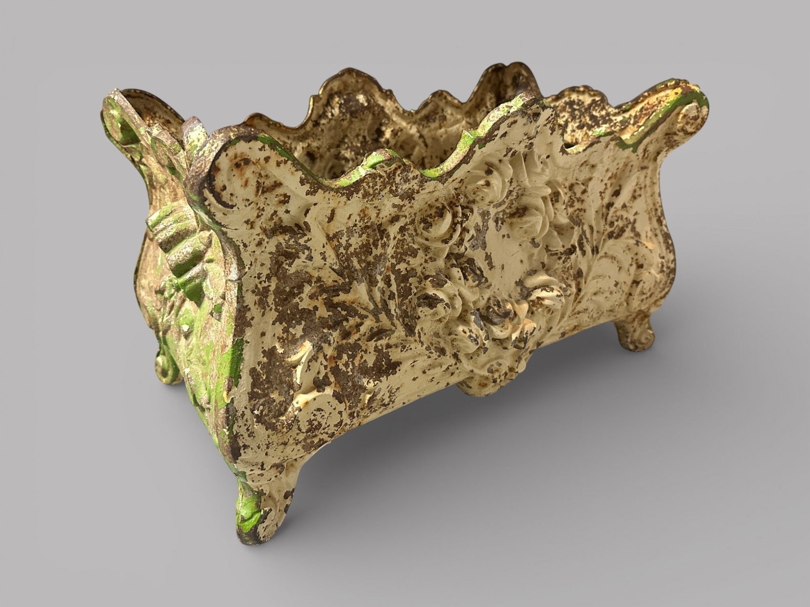 French Painted Cast Iron Garden Planter Jardiniere: with one side painted green and one side white H: 11 1/5 x w: 18 x d: 11 inchesCONDITION: rust and discoloration typical of outdoor exposure