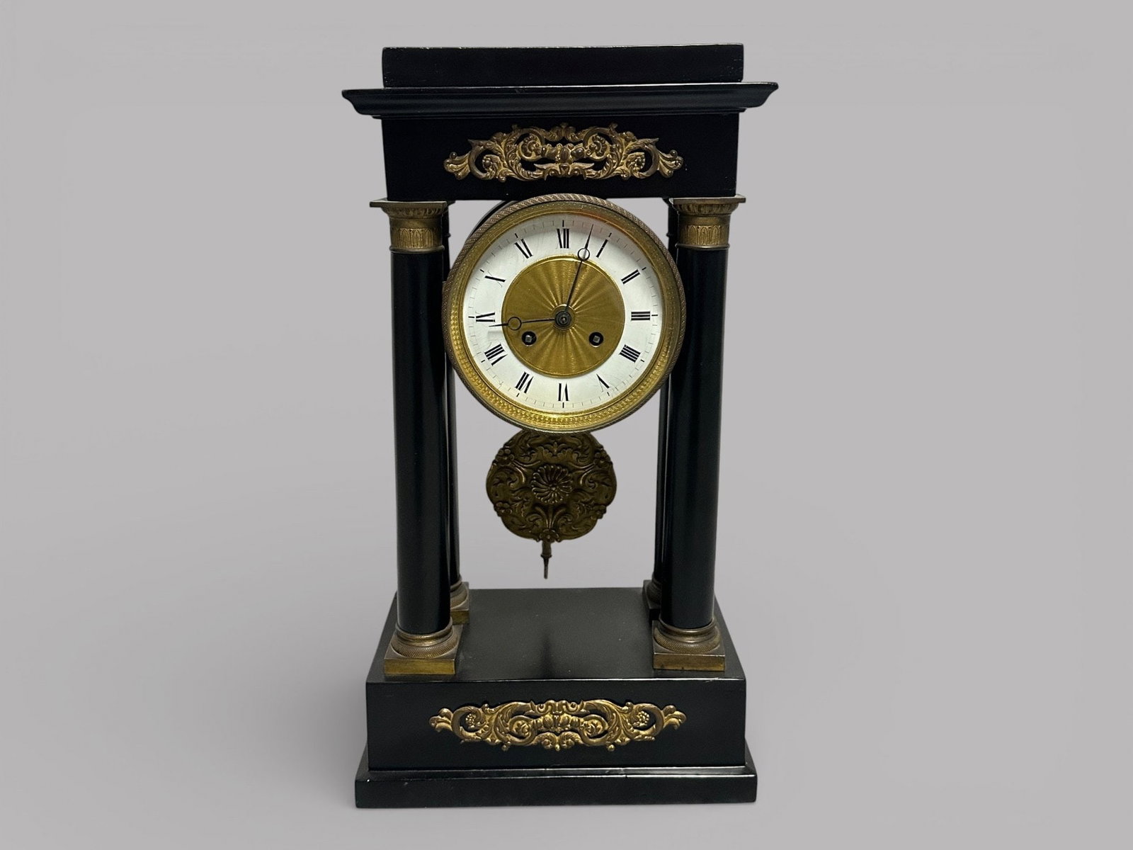 Empire Style Black And Gilt Metal Mounted Portico Clock, Late 19th Century: with key H: 19 1/8 x W: 10 1/2 x D: 5 3/4 inches