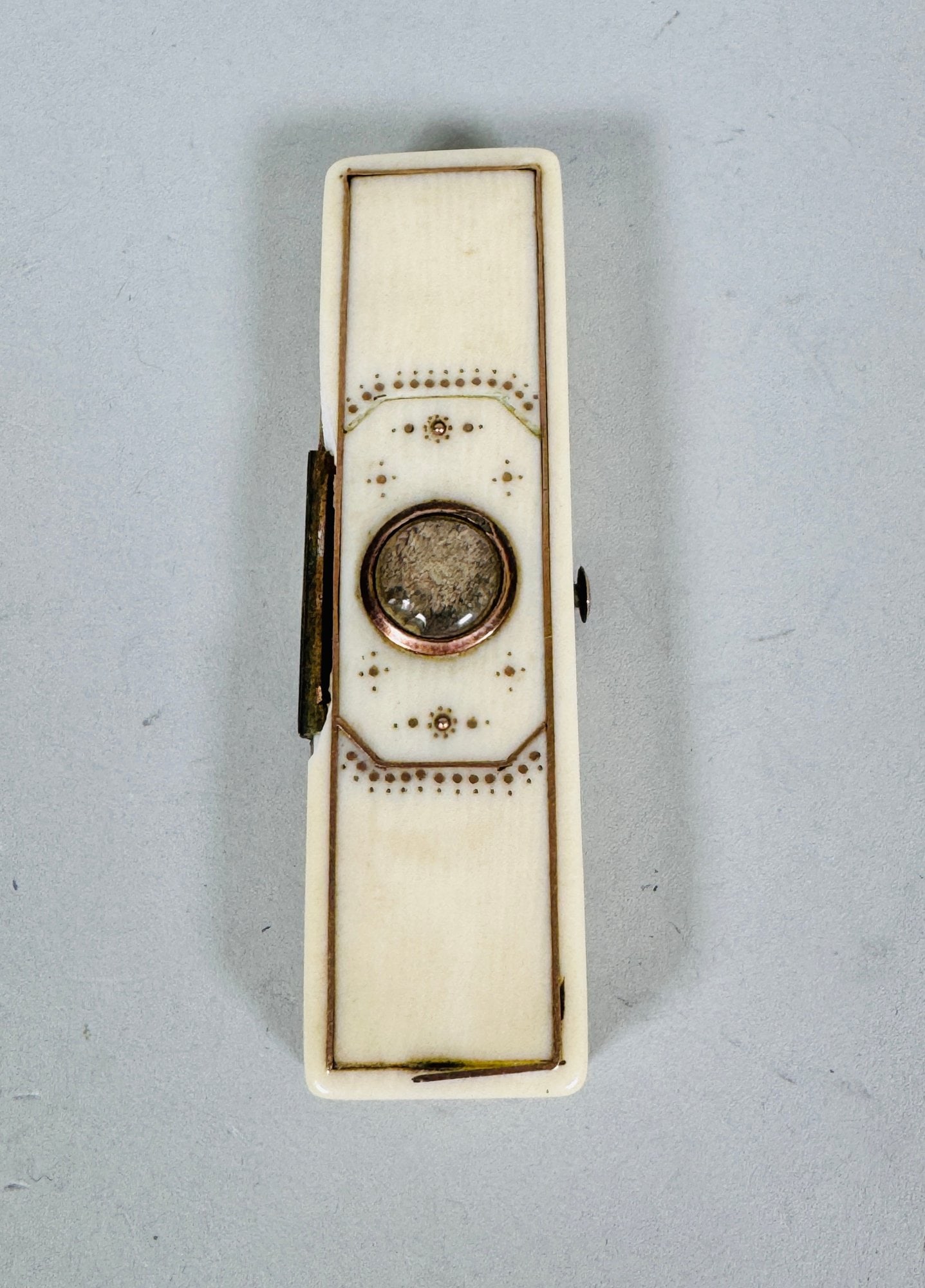 A Patch Box, Probably Georgian: The top inlaid with gold wire surrounding stylized hand painted decoration opening to velvet lining and mirror w: 2 1/2 inches CONDITION: hinge is loose piece is broken off near hinge gold inlay is li