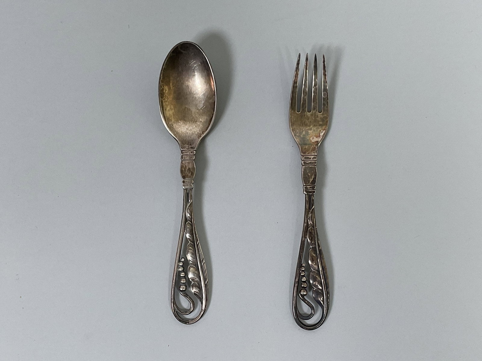 Vintage Georg Jensen Sterling Silver Child's Spoon And Fork Set: stamped sterling Denmark Length: 6 inches engraved SLM on back OZT: 1.99 total