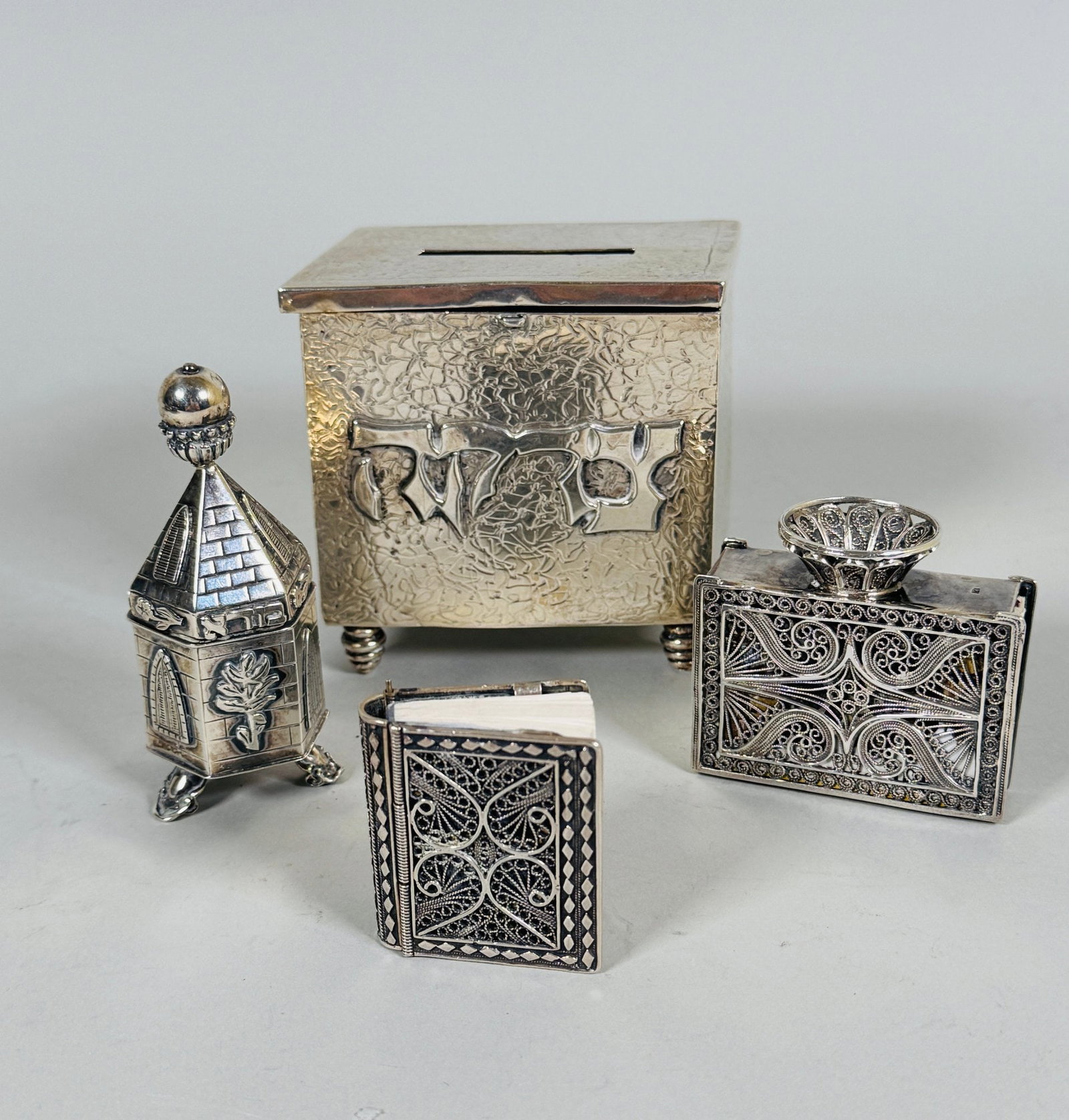 Collection Of Sterling Silver Judaica (4): including filigree matchbox holder marked 925 underneath h: 2 x w: 2 inches; filigree Tehilim cover stamped 925 inside h: 1 x w: 1 inches; spice box marked Israel/925 h: 3 inches; Tzedakah box marked 