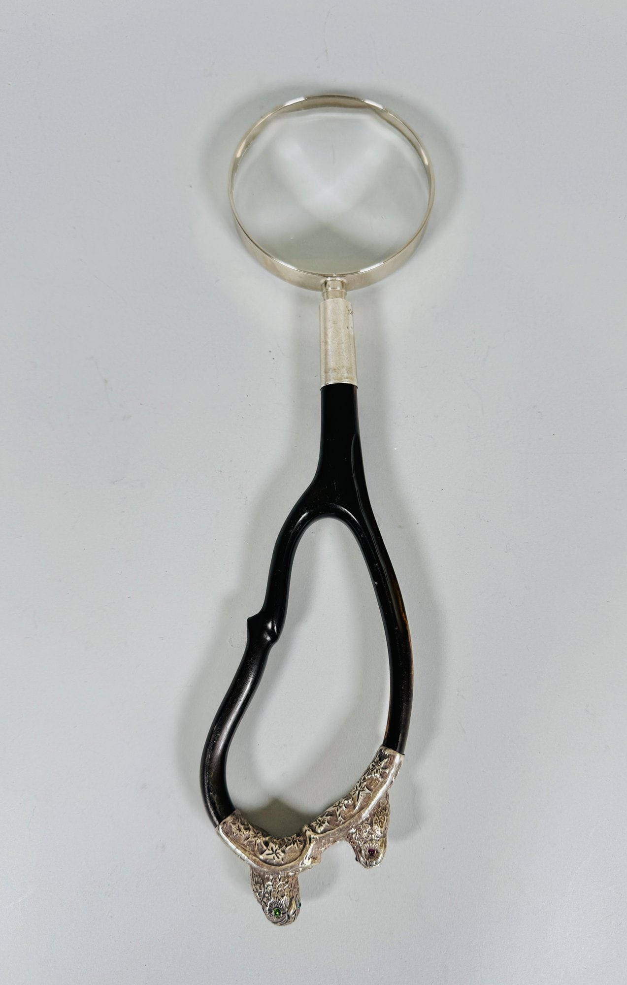Art Nouveau Silver Mounted Magnifying Glass: With ebonized wood handle mounted with silver figural owls having glass eyes perched on a branch at top of handle h: 12 inches CONDITION: one glass eye has been replaced light wear on handle the glass
