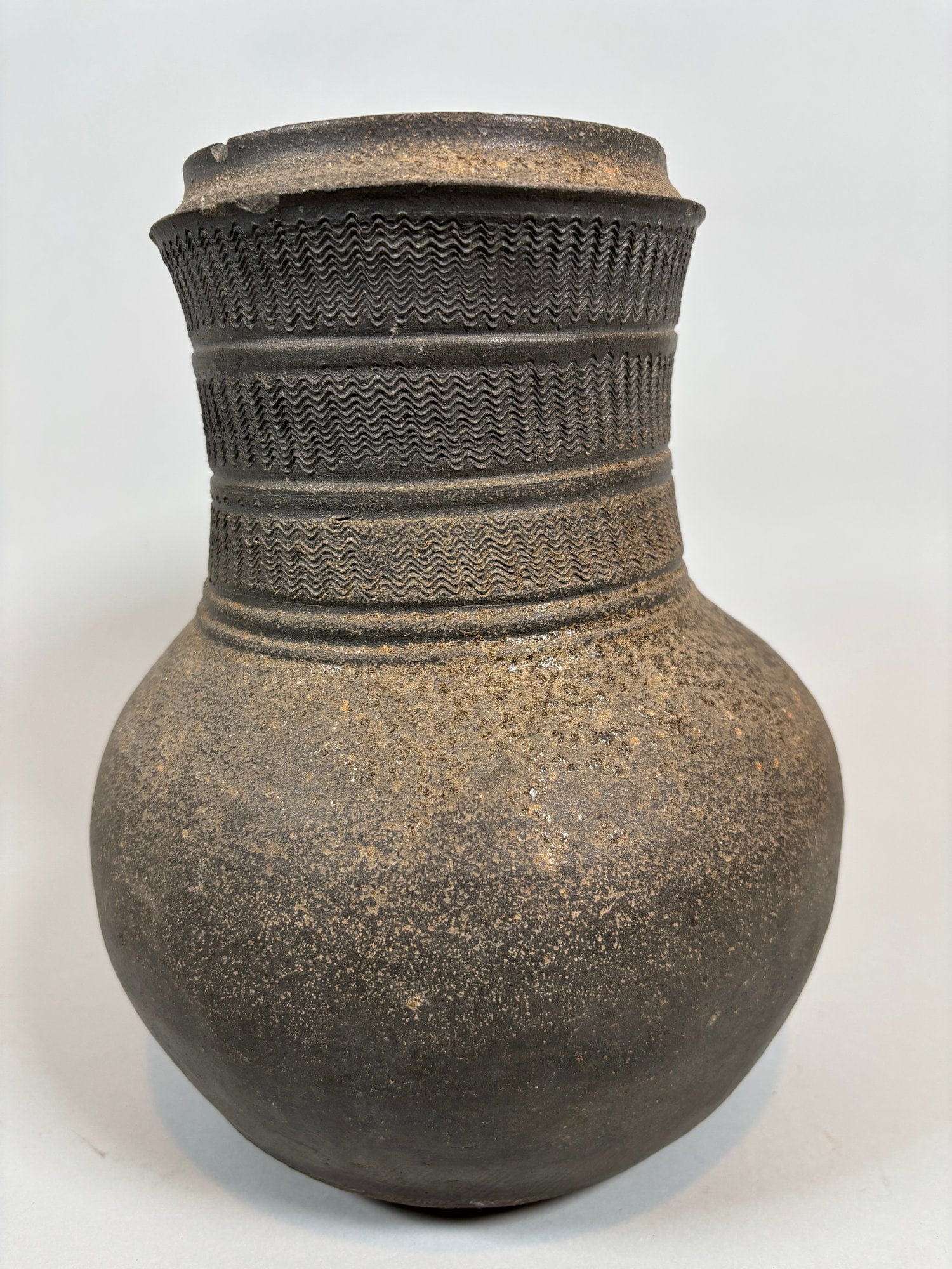 Korean Grey Stoneware Jar, Silla Dynasty: with incised designs at neck h: 10 x dia: 7 1/2 inches CONDITION: chips at mouth and neck